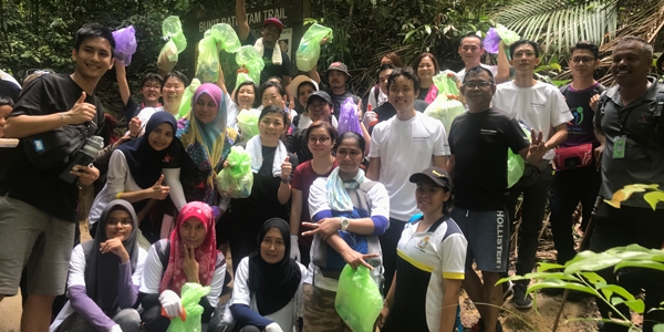 A large team of volunteers gathers to clean Kerachut Beach in Malaysia.