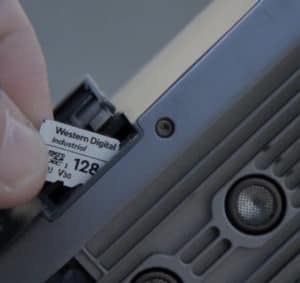 Operator inserts a 128GB Western Digital Industrial IX QD342 microSD™ card into a search and rescue drone.