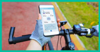 Cyclist looking at training data on a smartphone