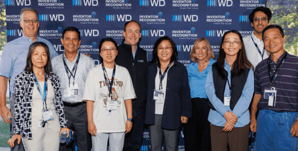 Ten WD inventor honorees and leaders posing together at WD Elevate event in front of WD Inventor Recognition branded backdrop.